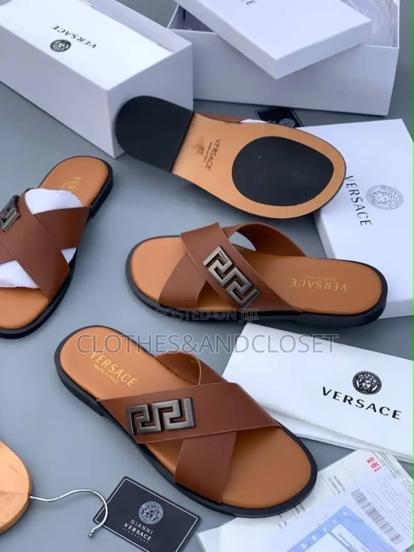 Stylish Black Leather Slides Feature a Striking Cross-Strap Desig