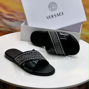Stylish Black Leather Slides Feature a Striking Cross-Strap Desig