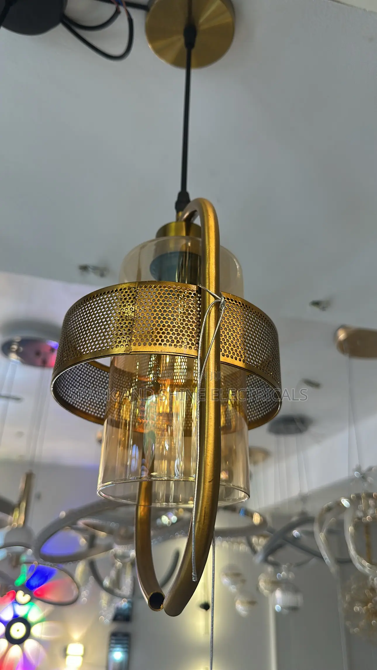Gold-Finished Pendant Light Featuring an Amber-Tinted Glass Cylinder