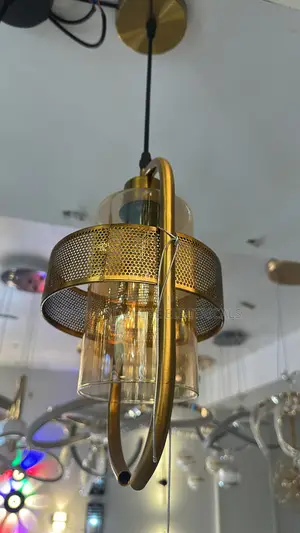 Gold-Finished Pendant Light Featuring an Amber-Tinted Glass Cylinder