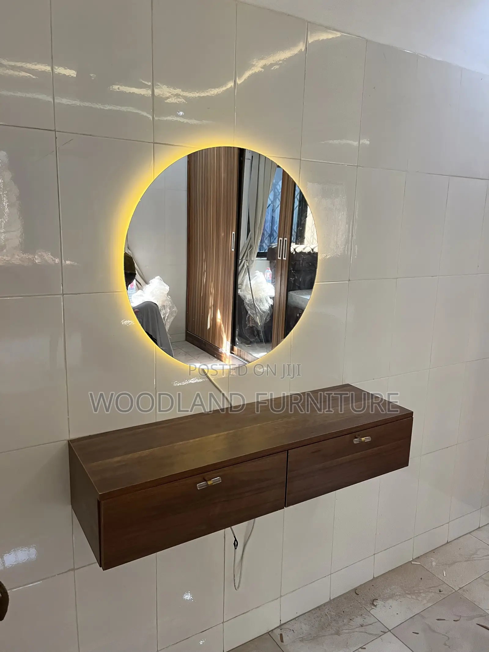 A Floating Walnut Vanity With a Warm Light Round Mirror Clean Lines