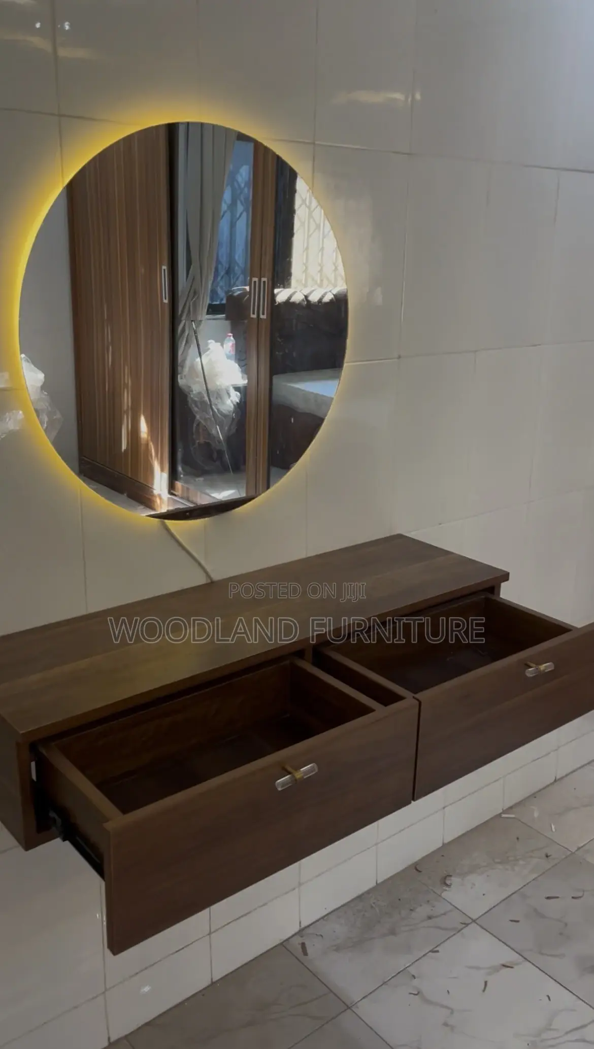 A Floating Walnut Vanity With a Warm Light Round Mirror Clean Lines