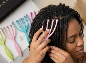 LOCS COMB. A 5-Claw Hand-Held Tool With Metal Beads Fitted at the Tips