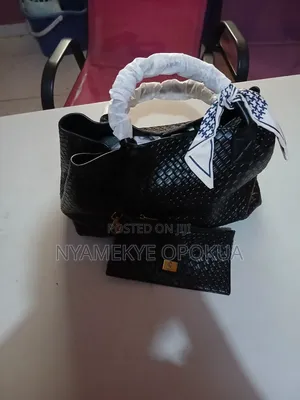 Stylish Black Woven Handbag Featuring a Gold Tone Hardware