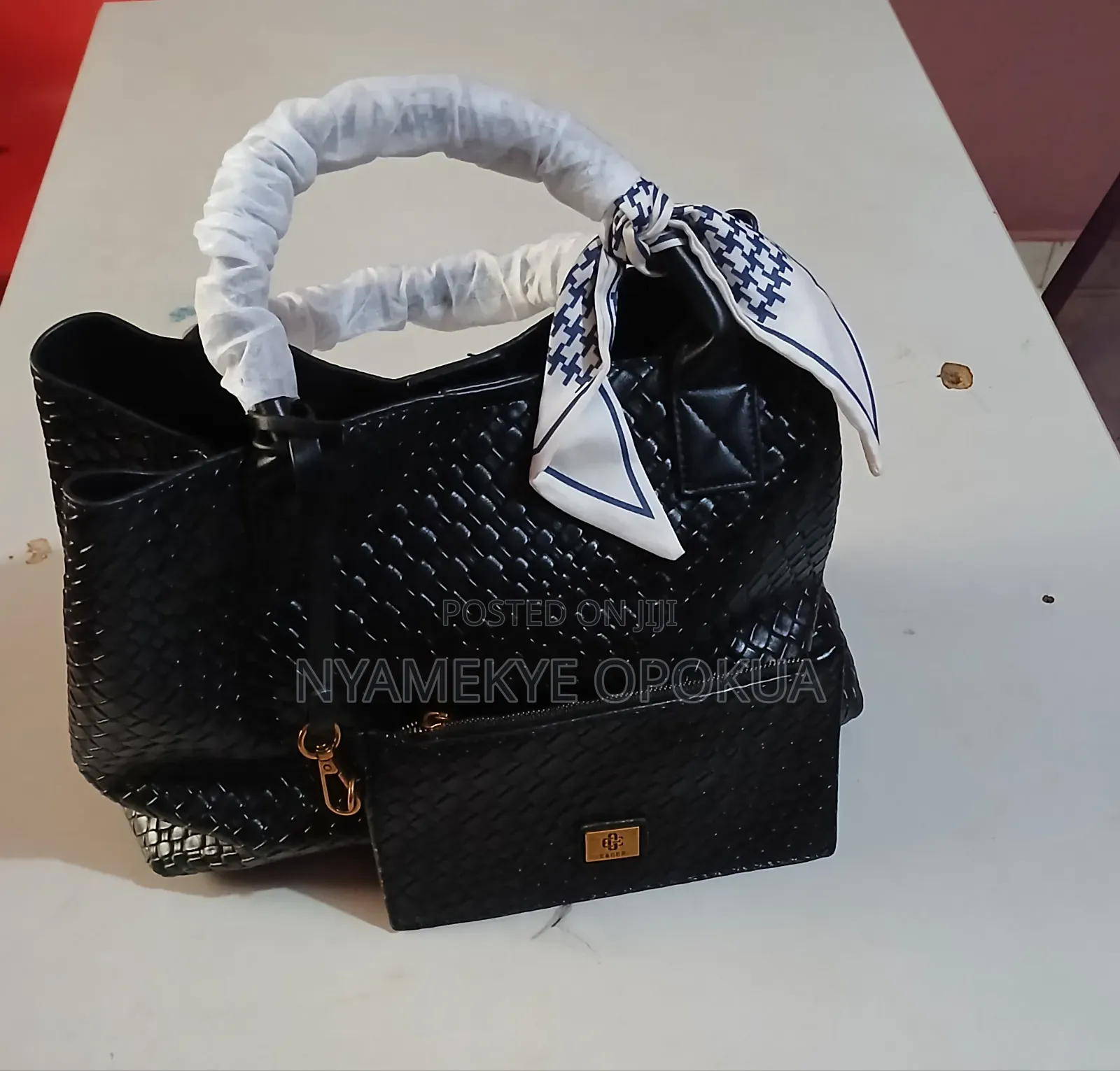Stylish Black Woven Handbag Featuring a Gold Tone Hardware