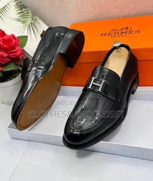 Black Leather Hermès Paris Men's Loafers Featuring a Signature Metalli