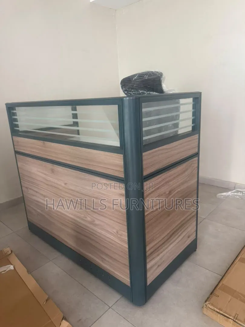 Receptionist Front Desk With a Wood Panel Finish.