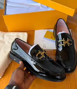 Black Patent Leather Loafers Mirror a Gold-Tone Metallic Buckle