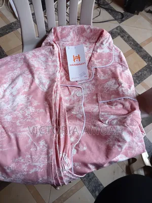 A Pink and White Printed Long- Sleeve Button- Down Pajama Set.