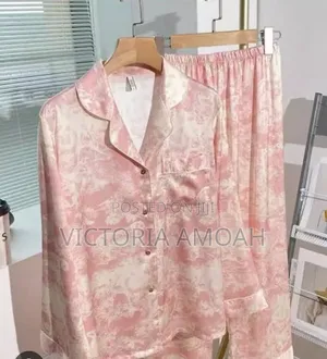 A Pink and White Printed Long- Sleeve Button- Down Pajama Set.