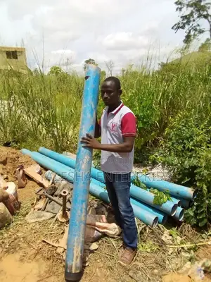 Borehole Drilling Services With Quality Pump and Blue Pipes